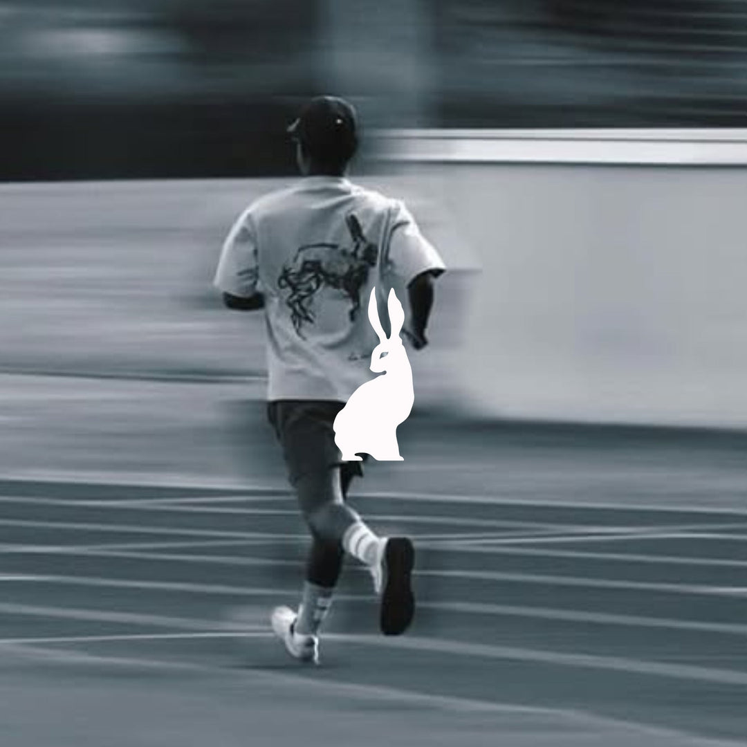 Man running on track with Lievre Running gear